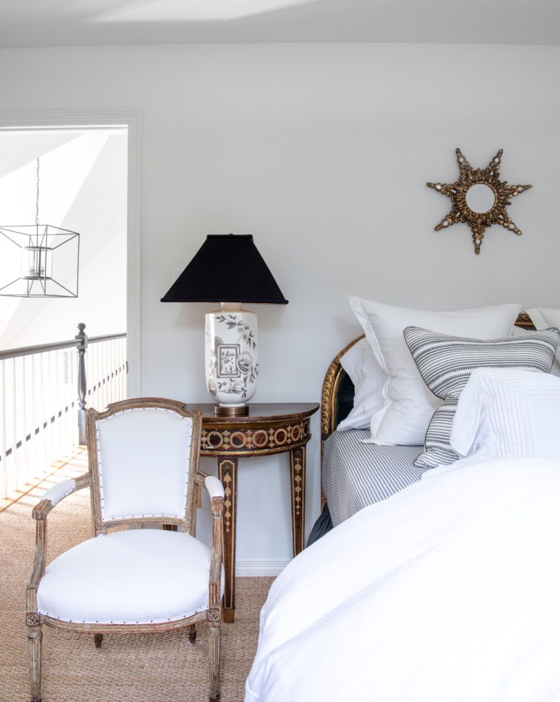 A guest bedroom’s side tables are antiques from Round Top. Shabby Slips toile lamps. Antique French chair. Gilded mirror from San Miguel. (Photo Jack Thompson)