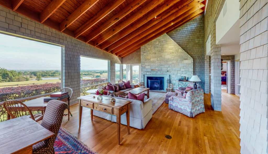 Glass-walled living room that brings the outside in.