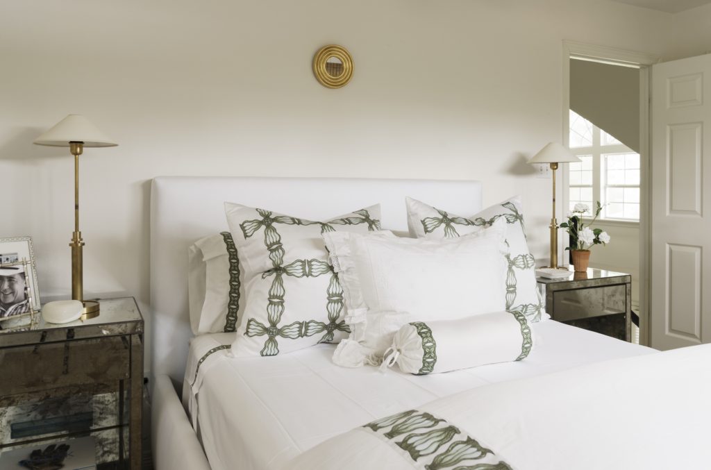 Tribute Goods linens in a guest bedroom. Visual Comfort lamps by J. Randall Powers. Petite gilded mirror is a San Miguel find. Mirrored tables from Skelton-Culver Antiques and Interiors. (Photo Jack Thompson.)