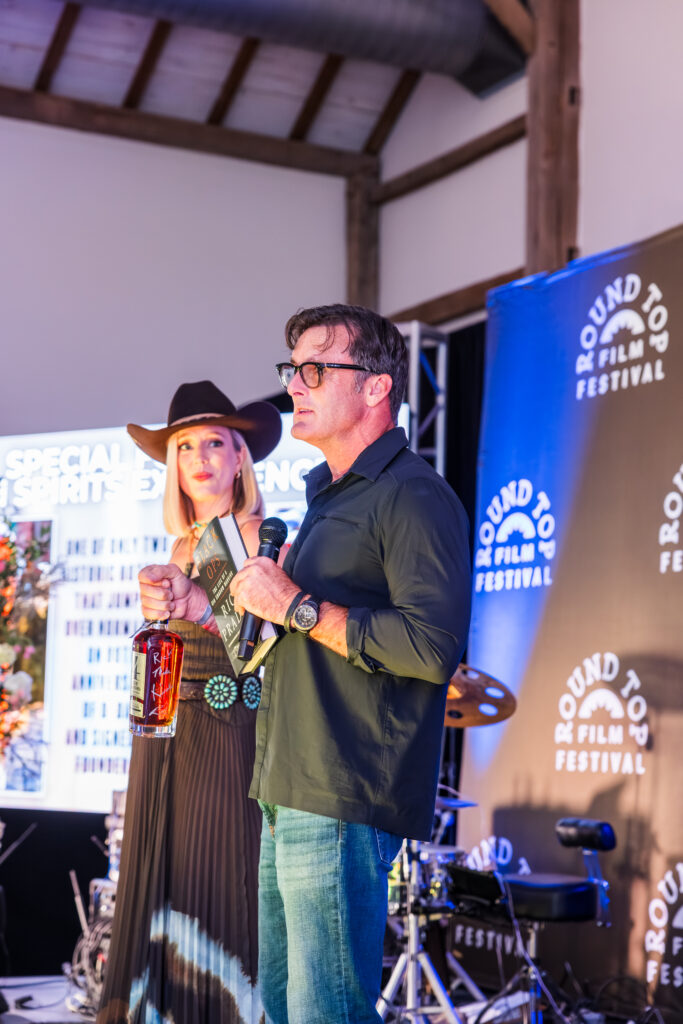 Auctioneer BiddyUp Carrie Fruge shares the stage with stuntman RJ Casey